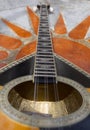 The national Greek stringed plucked musical instrument Bouzouki lies on a marble table in Greece