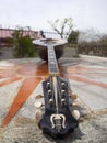 The national Greek stringed plucked musical instrument Bouzouki lies on a marble table in Greece