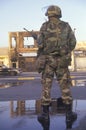National Guardsman standing in front of burned business after 1992 riots, South Central Los Angeles, California