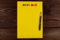 National Happy Boss Day. Multicolored colorful letters in a yellow blank page with pen on the table. Bosses day office