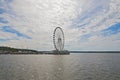 Sun shines through cumulus clouds on the Ferris of National Harbor in Oxon Hill, Maryland, USA. Royalty Free Stock Photo