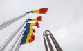 National Heroes Memorial Monument in Carol Park from Bucharest - wide view in a cloudy day with Romanian flags in foreground