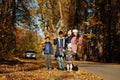 National holiday of United Kingdom. Family with british flags in autumn park. Britishness celebrating UK. Mother with four kids