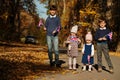 National holiday of United Kingdom. Four kids with british flags in autumn park. Britishness celebrating UK