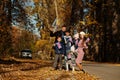 National holiday of United Kingdom. Large family with four kids holding british flags in autumn park. Britishness celebrating UK