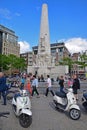 National Monument on Dam Square with motorcycles and heavy crowd