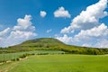 National mystic hill Rip, Central Bohemia, Czech republic - spring landscape with green fields and blue sky with clouds Royalty Free Stock Photo