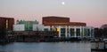 National Opera Museum in Amsterdam with full moon and Amstel river in foreground