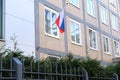 National red, blue, white flag of state of Russian Federation on silk on facade of building of Consulate General of Russia,