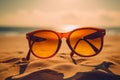 National sunglasses day a pair of stylish shades laying on the golden sand of a sun drenched beach.