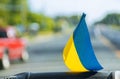 National symbol. Blue-yellow flag of Ukraine. Patriotic sign on glass inside the car