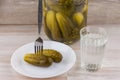 National trait harmful to health: a large jar of pickles and faceted glass of Russian vodka on a white table, a couple of Royalty Free Stock Photo