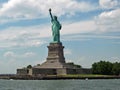 Statute of Liberty near Ellis Island with Cloudy sky Background Royalty Free Stock Photo