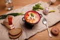 National Ukrainian borshch or borscht with beetroot, potatoes, cabbage served with sour cream, fresh greenery, lard, rye bread Royalty Free Stock Photo