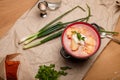 National Ukrainian cuisine. Borscht or borsch, lard in red pepper, green onions and parsley. Vodka bottle on paper Royalty Free Stock Photo