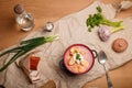 National Ukrainian cuisine. Lard in paprika, borscht with sour cream, rye bread, greenery and vodka bottle. Cottage meal Royalty Free Stock Photo