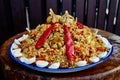 National Uzbek dish pilaf. Cooking in a cauldron on fire. Spread beautifully on a national plate lyagan rice, from above Royalty Free Stock Photo