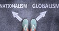 Nationalism and globalism as different choices in life - pictured as words Nationalism, globalism on a road to symbolize making