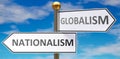 Nationalism and globalism as different choices in life - pictured as words Nationalism, globalism on road signs pointing at