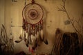 native american dreamcatcher hanging against a simple wall