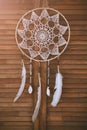 Native american indian magical dreamcatcher with sacred feathers. amulet on wooden background. Shaman Royalty Free Stock Photo