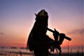 A Native American Indian plays music on a bamboo flute.