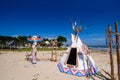 Native american indian tepee and totem pole on the beach blue sk Royalty Free Stock Photo