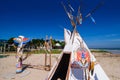 Native american indian tepee and totem pole on the beach blue sk Royalty Free Stock Photo