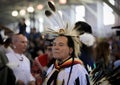 Native American Indian wearing a porcupine roach and a traditional outfit dancing at a powwow in San Francisco, USA