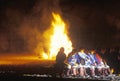 Native American men sitting in front of bonfire