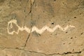 Native American petroglyphs featuring an image of a snake at Petroglyph National Monument, outside Albuquerque, New Mexico Royalty Free Stock Photo