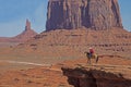 A native American walks his horse in Monument Valley. Royalty Free Stock Photo