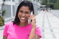 Native american woman speaking at phone in the city