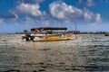 Native Guna people boat and huts on Caribbean San Blas island at politically autonomous Guna territory in Panama