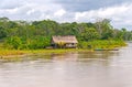 Native house along a rain forest river Royalty Free Stock Photo