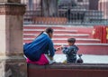 Native Indigenous happy mother and son sit in traditional colorful dress, Mexico, America