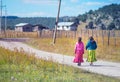 Indigenous poor school girl in traditional colorful dress walk on the way to home, Mexico, America Royalty Free Stock Photo