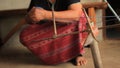 Native Karen Sgaw hill tribe woman rolling a ball of blue dyed thread in preparation for hand weaving traditional clothing and cra