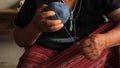 Native Karen Sgaw hill tribe woman rolling a ball of blue dyed thread in preparation for hand weaving traditional clothing and cra