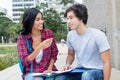 Native latin american female student in discussion with caucasian friend Royalty Free Stock Photo