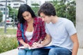 Native latin american female student learning with caucasian fri Royalty Free Stock Photo