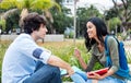 Native latin american student in discussion with friend Royalty Free Stock Photo