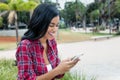 Native latin american woman receiving snapshot on phone Royalty Free Stock Photo