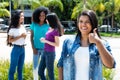 Native latin american woman showing thumb with group of girlfriends Royalty Free Stock Photo