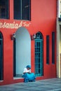 Native lonely Indigenous lady in traditional colorful dress with a beautiful house, in Mexico, America Royalty Free Stock Photo