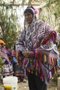 Native Peruvian man wearing a handwoven poncho and a chollo