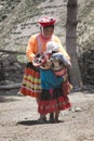 Native peruvian woman smilling and playing with her kids