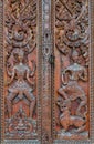 Native Thai style carving, painting on church door in the temple Royalty Free Stock Photo