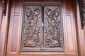 Native Thai style carving, painting on church door in the temple Royalty Free Stock Photo