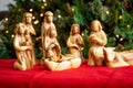 Nativity Creche Made of Olive Tree Wood Against a Lighted Background With Baby Jesus Royalty Free Stock Photo